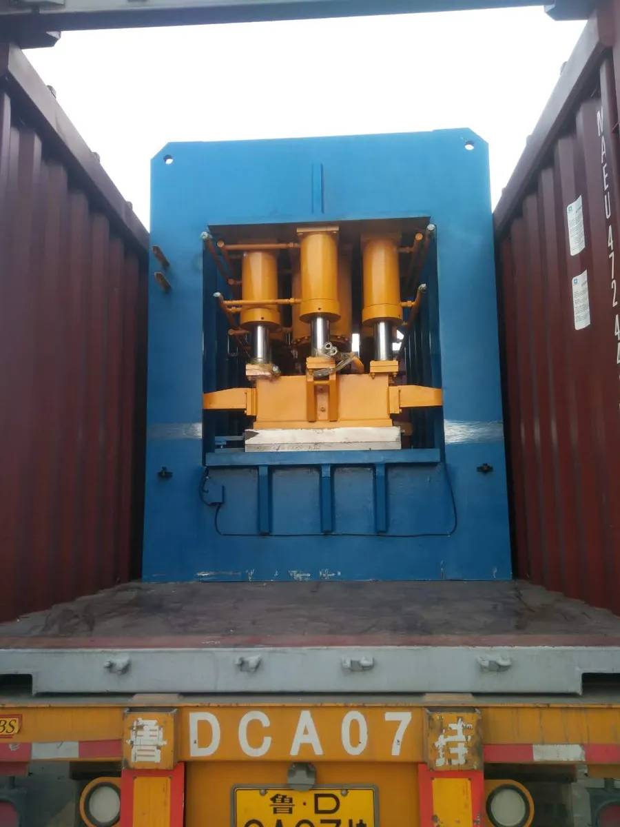 Hydraulic press secured inside a shipping container